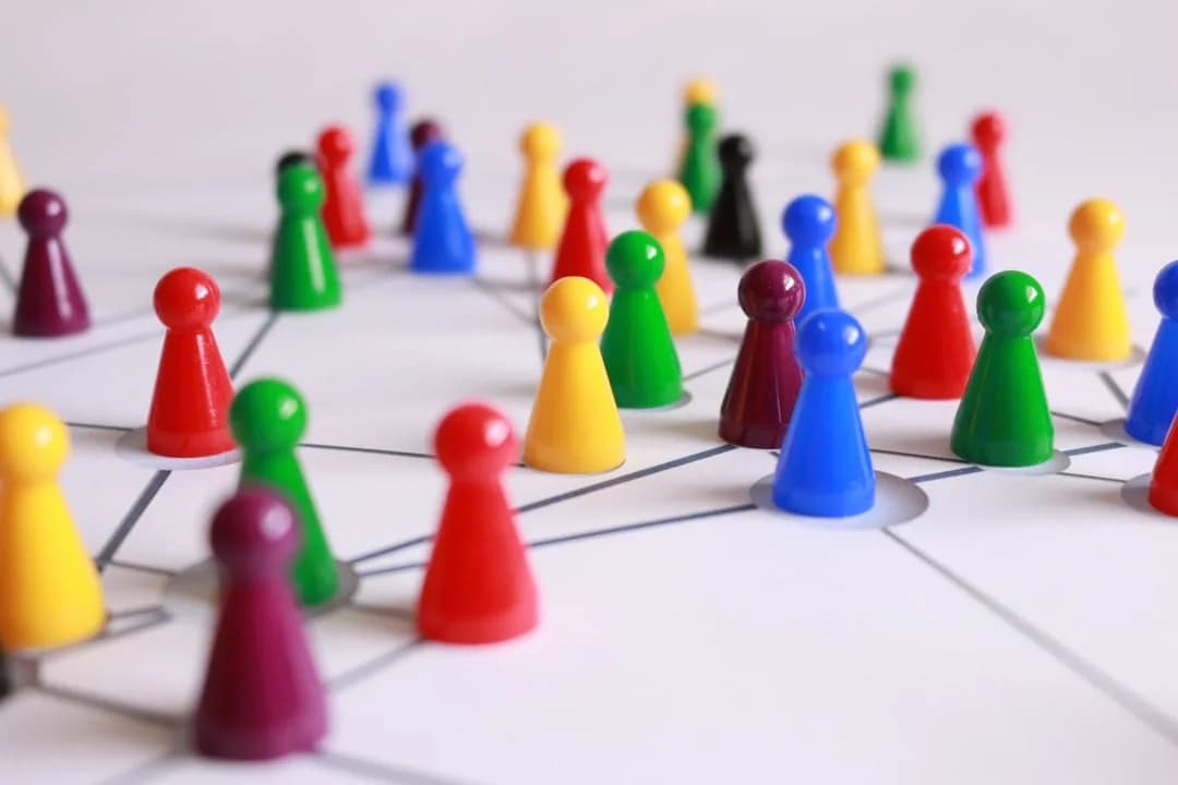 Colorful game pawns connected by a network of lines, representing participants linked in an ESM study