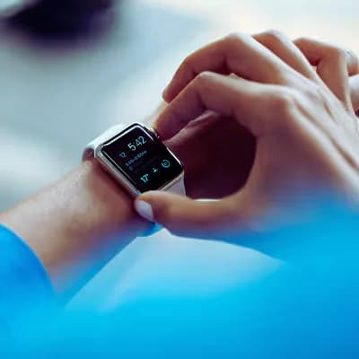 Person checking a health-tracking smartwatch on their wrist